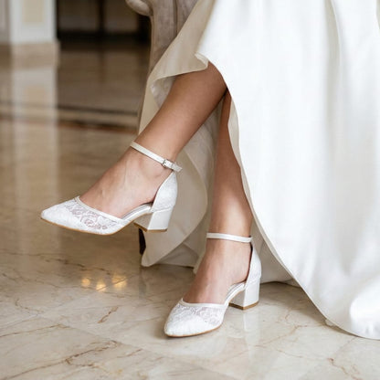 Closed toe d'orsay style bridal heels with block heel and ankle strap in ivory white.