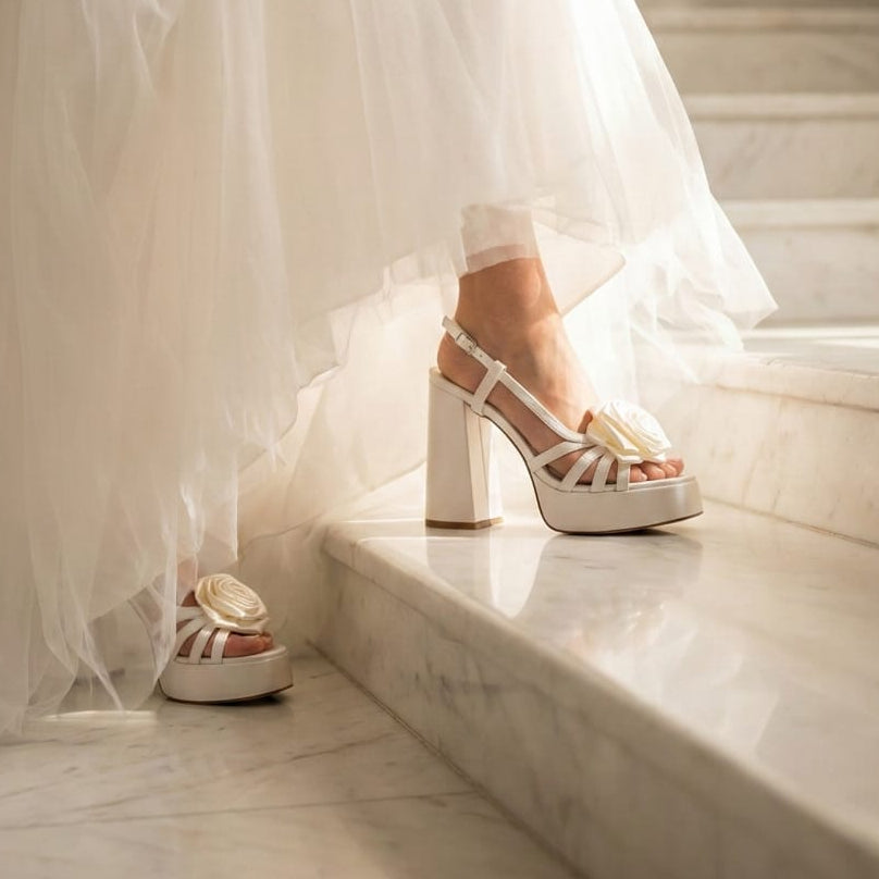 Bride wearing a wedding dress and wedding high-heeled shoes on a marble staircase in Beirut