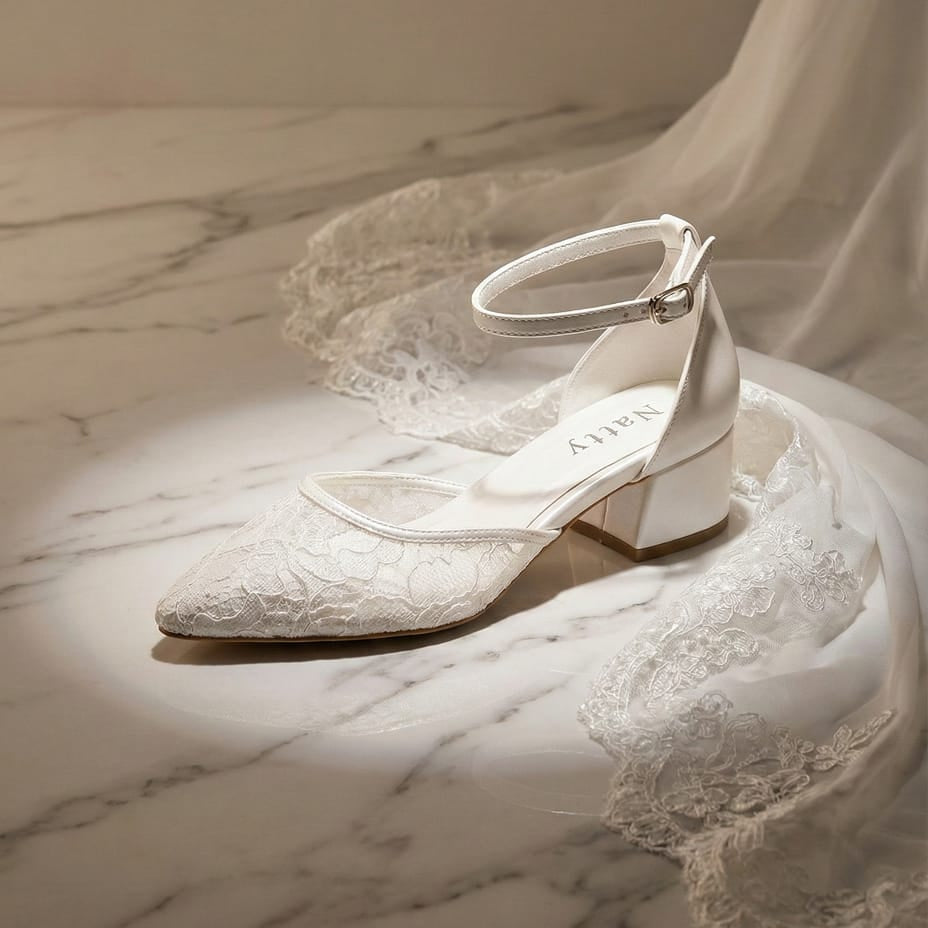 Elegant floral lace wedding pumps with satin Lace heel cup and reflective marble background.