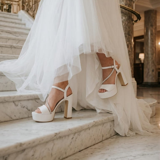 White wedding dress with high-heeled bridal sandal shoes double semelle on marble steps in a grand interior setting in Beirut Lebanon