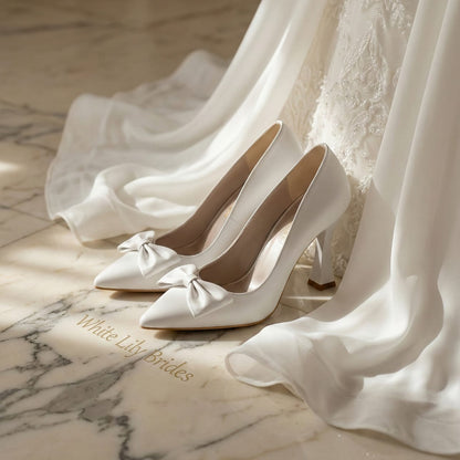 High-quality smooth white wedding heels with a sophisticated bow design, photographed in Beirut, Lebanon