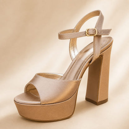 A single nude champagne gold platform sandal with a high block heel, open toe, and ankle strap with a gold buckle, set against a matching beige background. in Lebanon