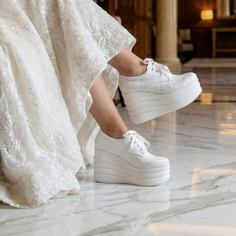 Bride wearing a white wedding  lace dress and platform bridal sneakers rock in an elegant interior setting in Lobby in Beirut
