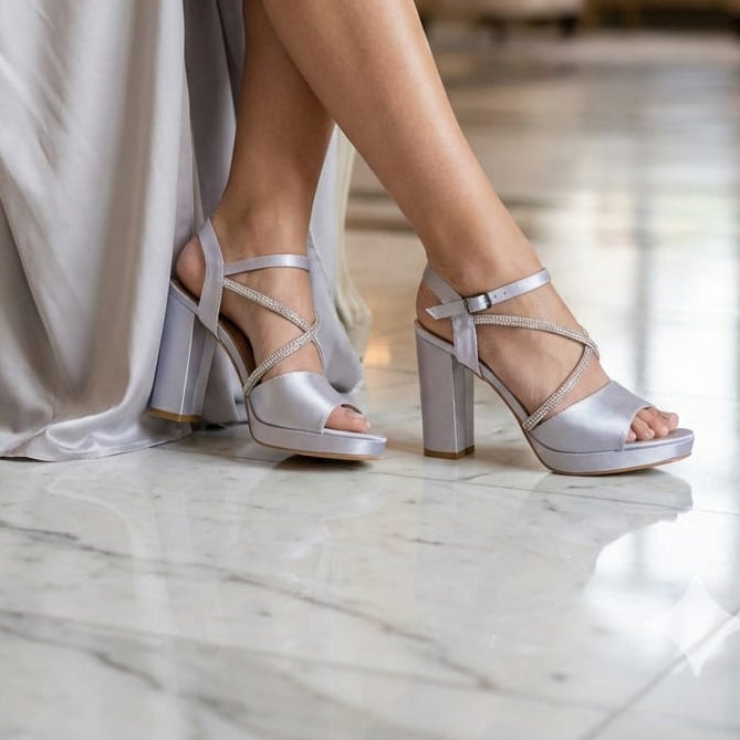 Person wearing silver high-heeled shoes sitting on a chair in a room with marble floor in beirut lobby