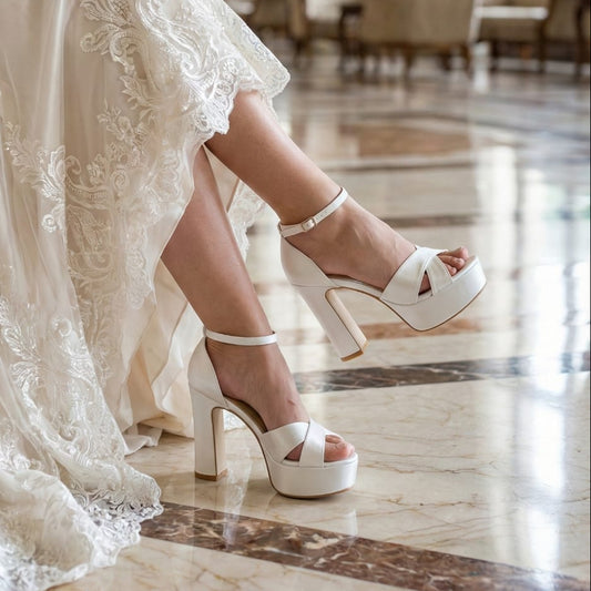 Bride wearing a white lace wedding dress and wedding high-heeled shoes in an elegant indoor setting in Lebanon Beirut.
