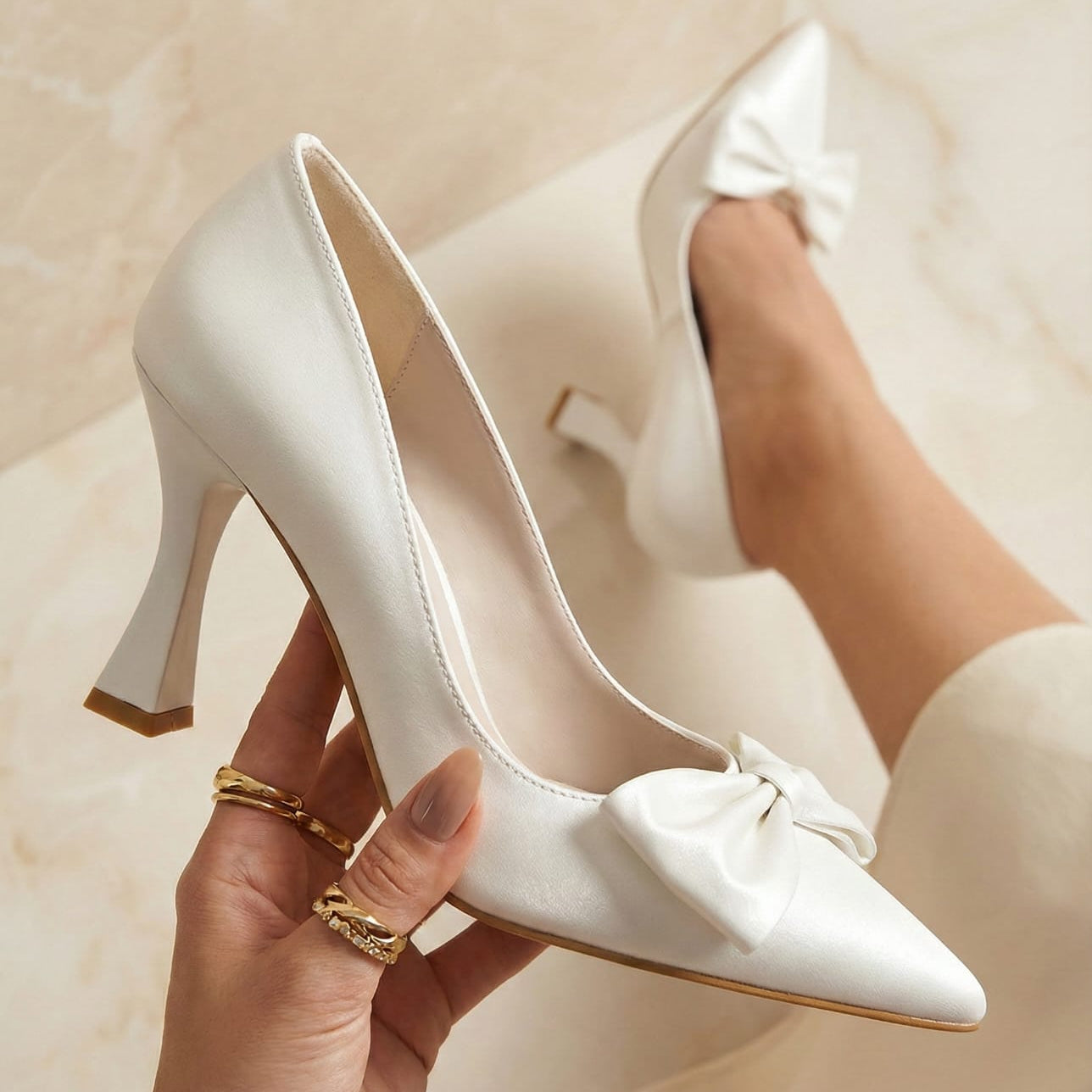 Close-up of white bridal pumps featuring a pointed toe and elegant bow detail, available at bridal boutiques in Beirut, Lebanon.