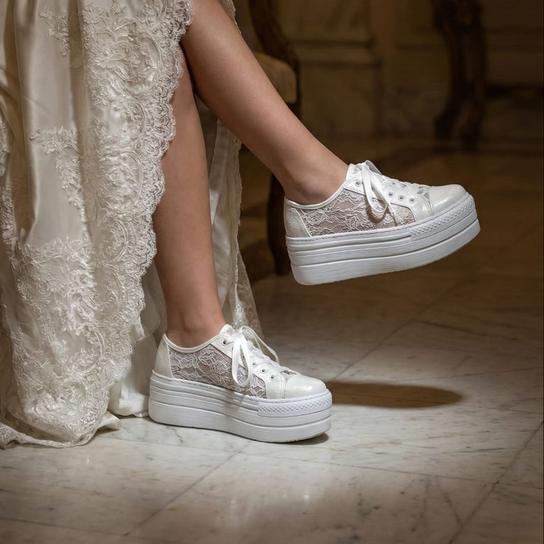 Side profile of white lace platform bridal sneakers with satin ribbon laces and intricate floral detailing, wedding footwear trends in Beirut, Lebanon.
