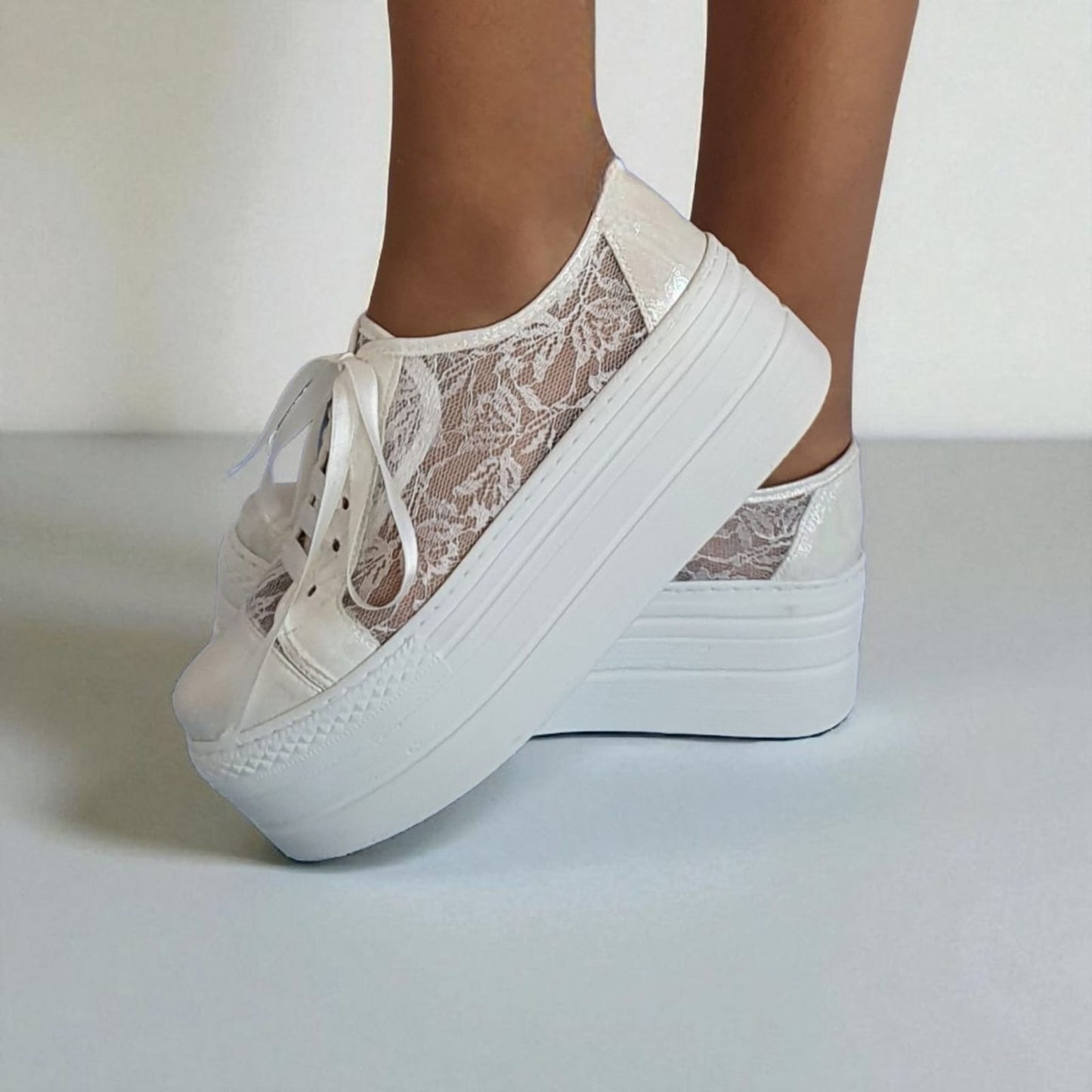 White lace platform bridal sneakers for weddings, featuring intricate floral lace detailing and satin ribbons, available in Beirut, Lebanon.