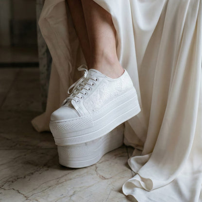 White Lily Brides white lace platform wedding sneakers with a detailed lace texture and ribbon laces, worn by a bride in a luxury hotel lobby in Beirut, Lebanon.
​